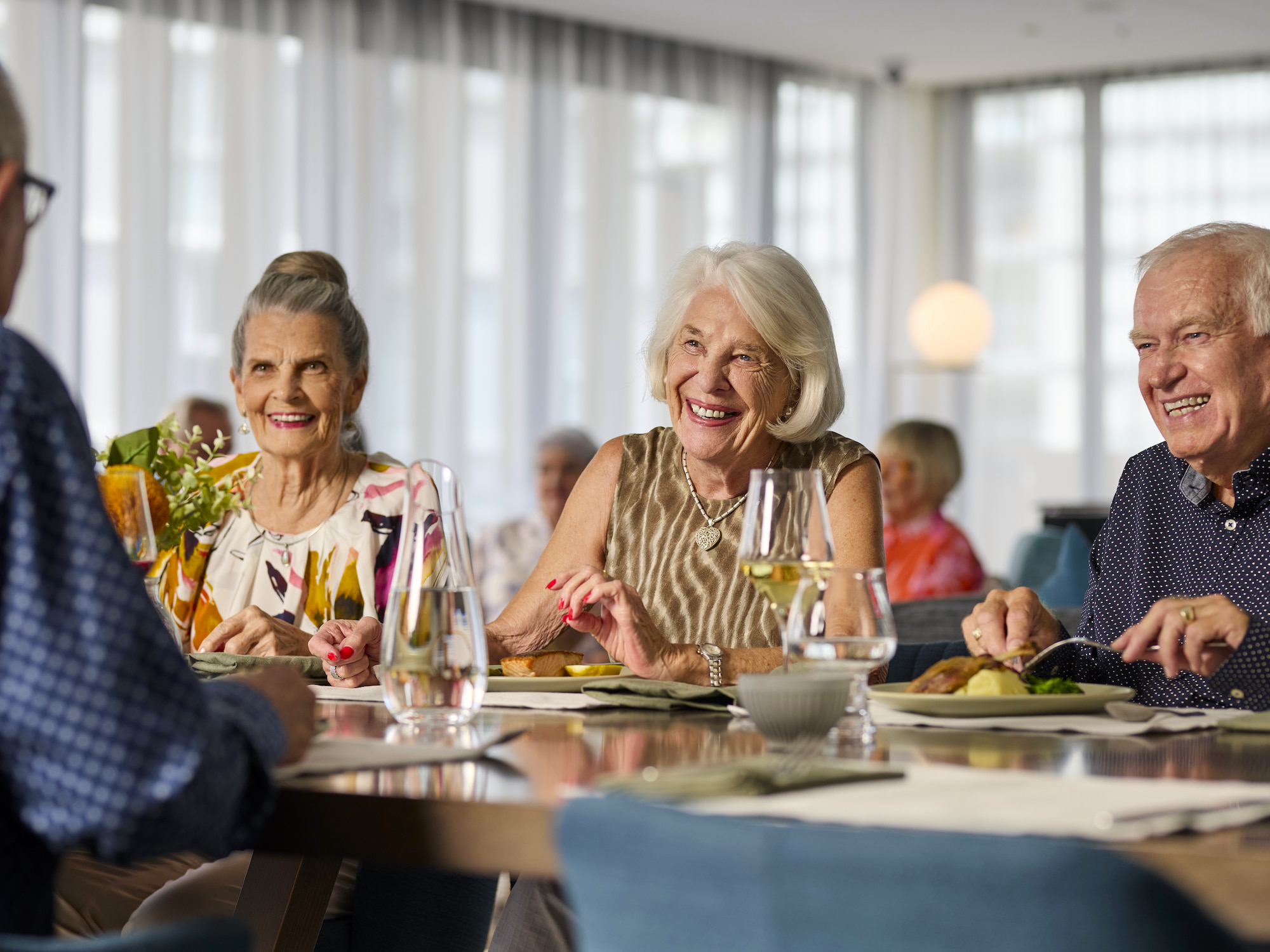 Residents having dinner and drinks together 